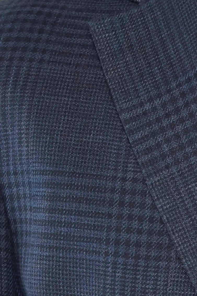 Close-up of a textured blue fabric with a check pattern