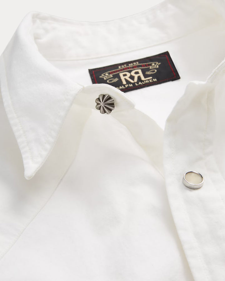 Close-up of a white dress shirt with cufflinks and a Ralph Lauren label.