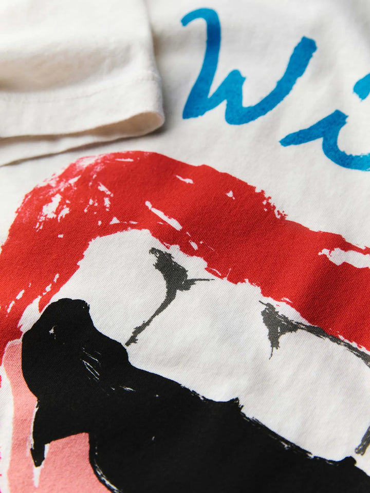 Close-up of a white shirt with red and blue graphics and text.