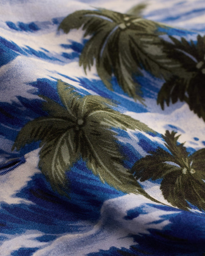 Close-up of fabric with palm tree pattern on blue and white background