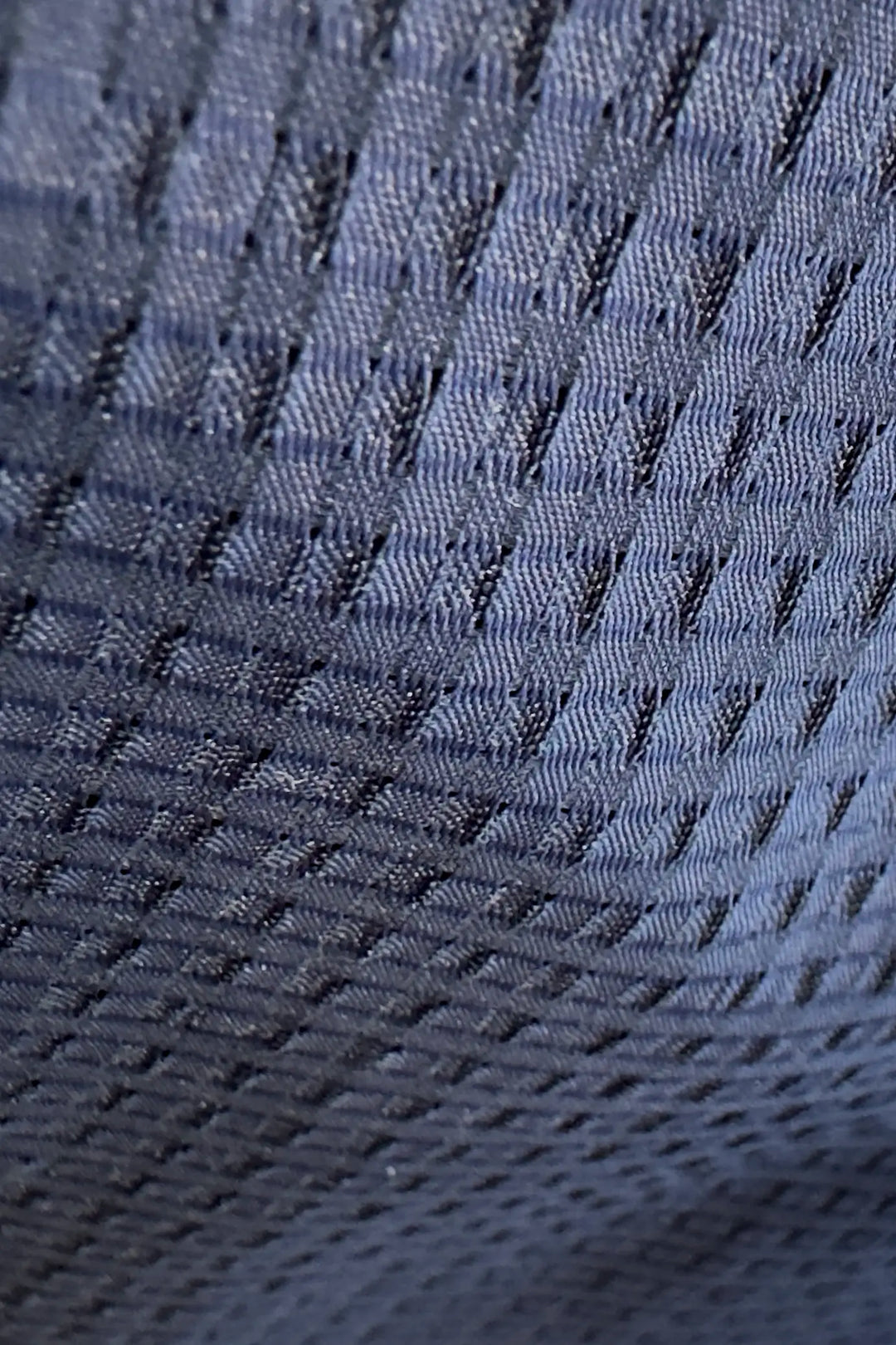 Close-up of textured blue fabric with a diamond pattern