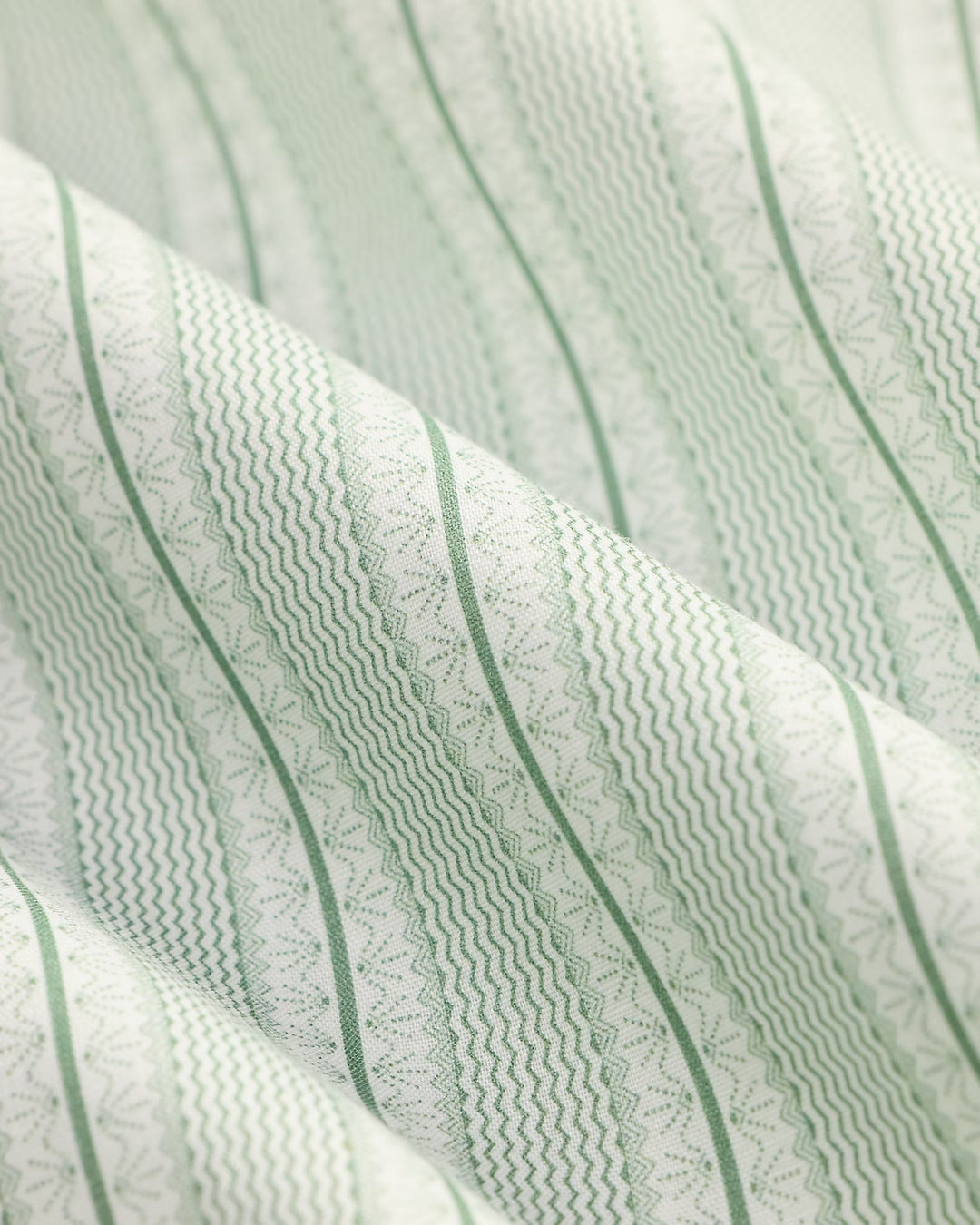 Close-up of textured fabric with green stripes and patterns