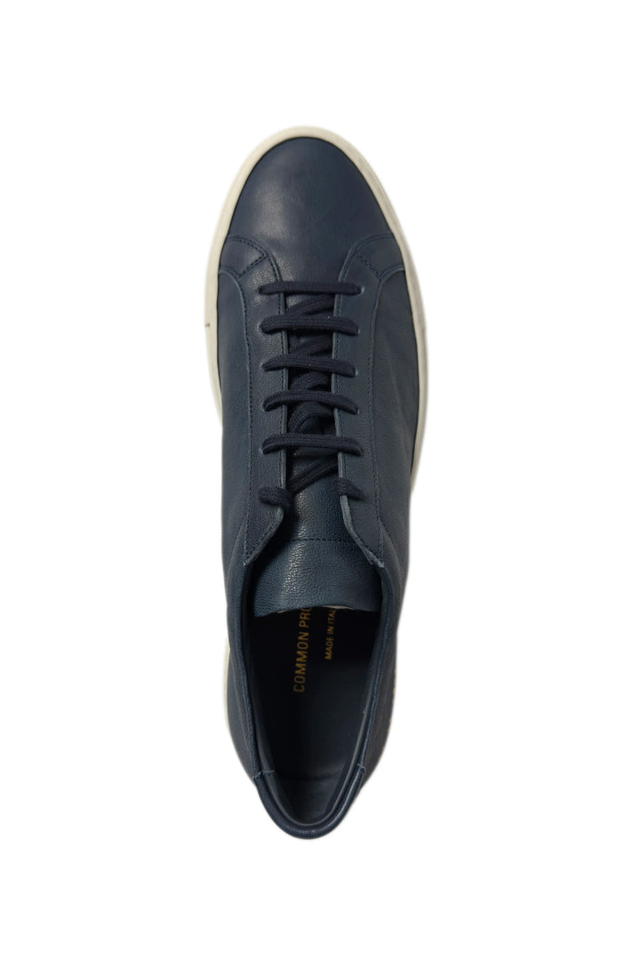 Navy blue leather sneaker on a white background