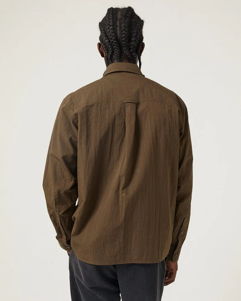 Person wearing a brown jacket on a white background