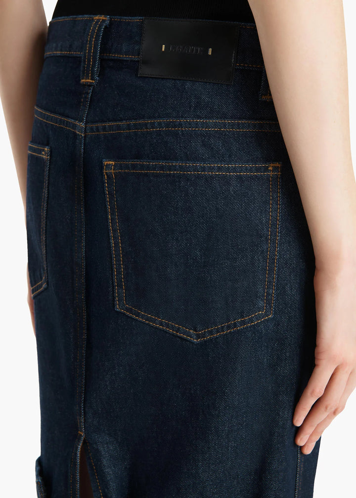 Dark blue denim jeans with a brand label on a white background