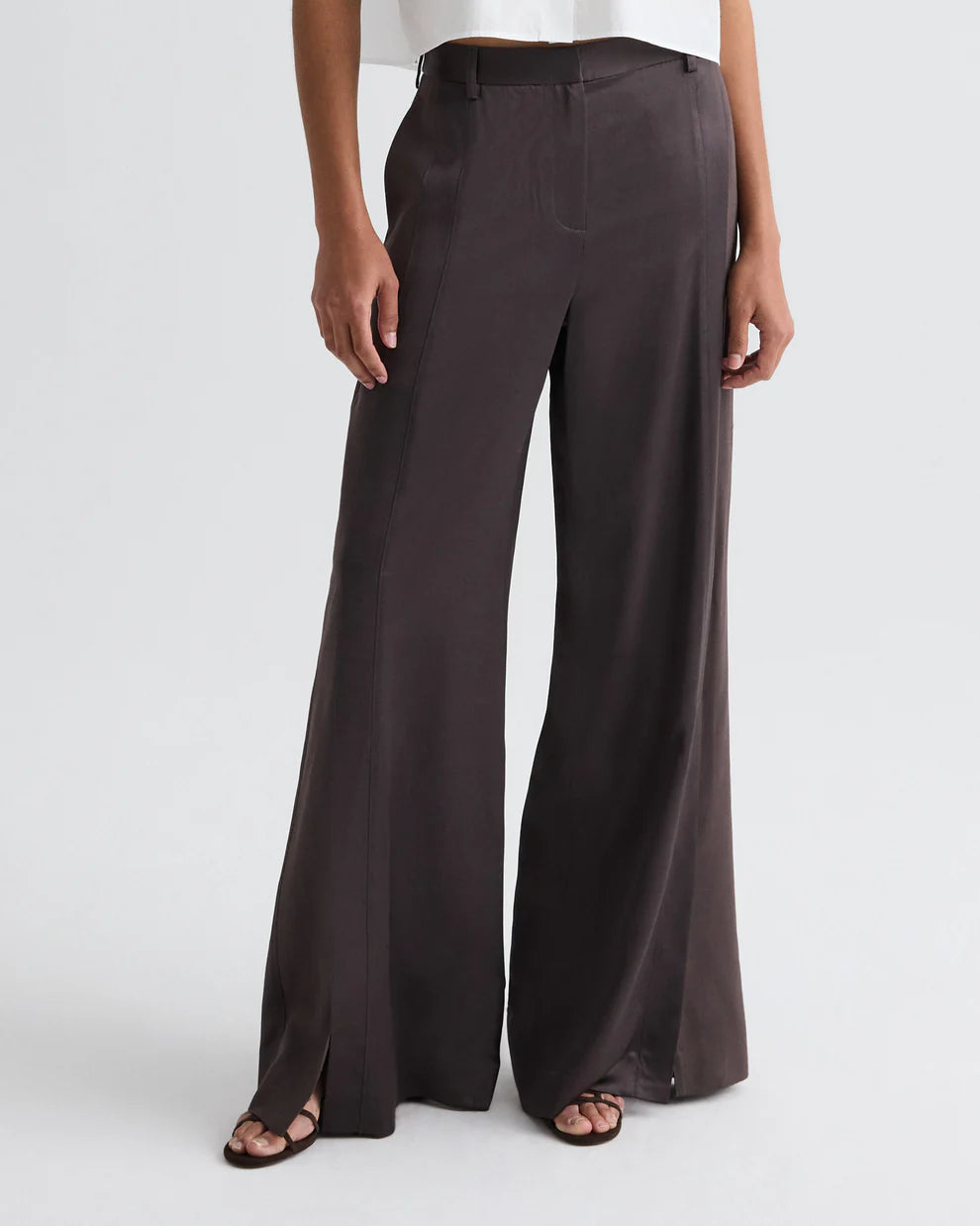Dark brown wide-leg pants worn by a person on a white background