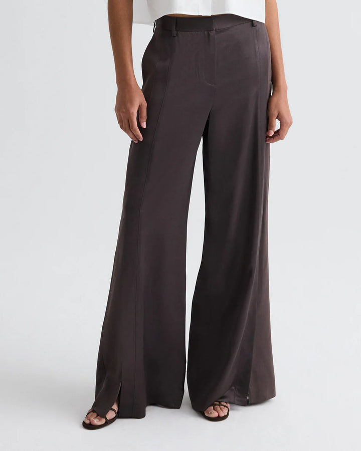 Dark brown wide-leg pants worn by a person on a white background