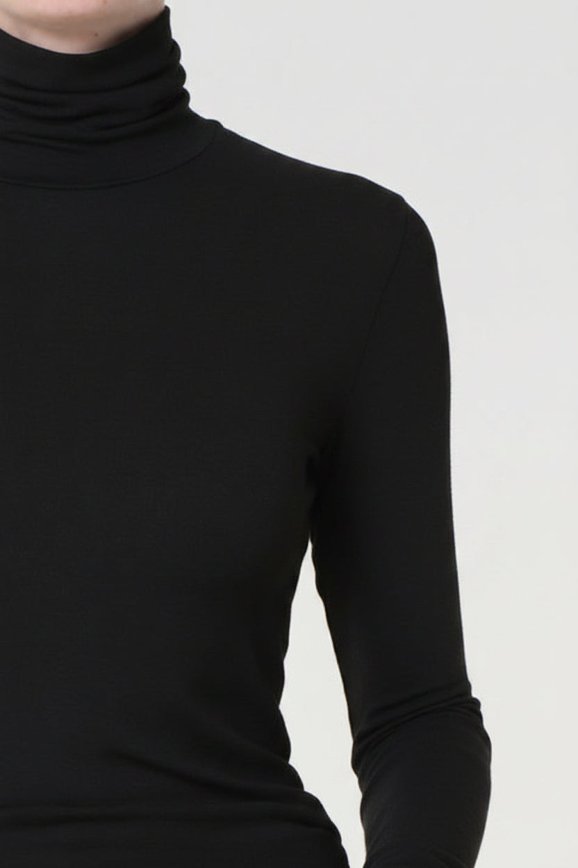 Dark gray turtleneck sweater on a plain background