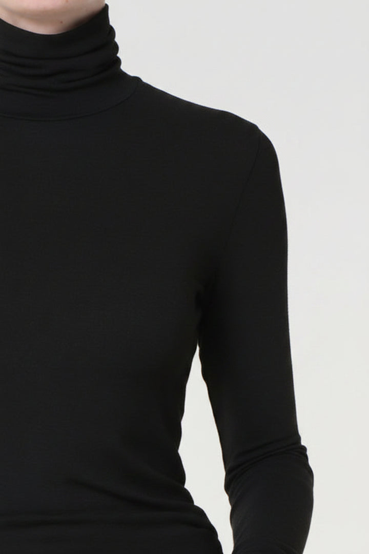 Dark gray turtleneck sweater on a plain background