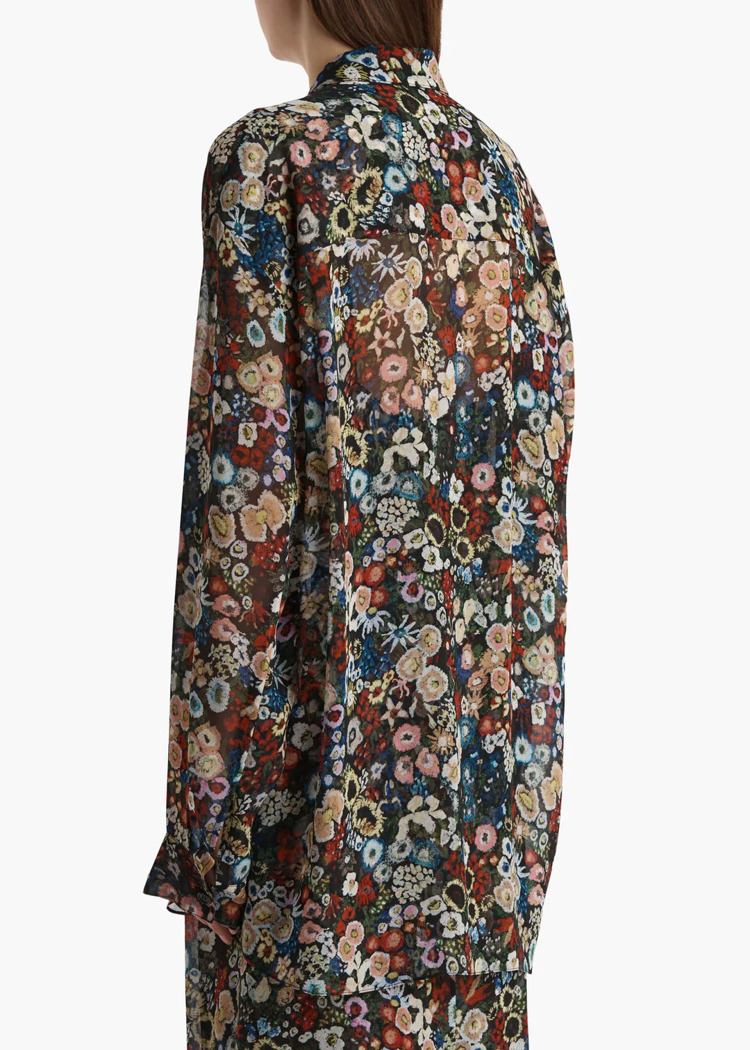 Floral patterned shirt worn by a person on a white background