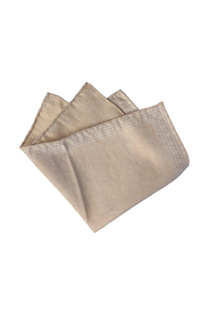 Folded beige napkin on a white background