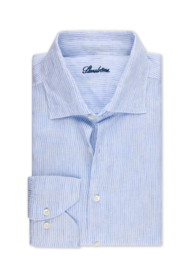 Folded light blue striped dress shirt with a brand logo on a white background