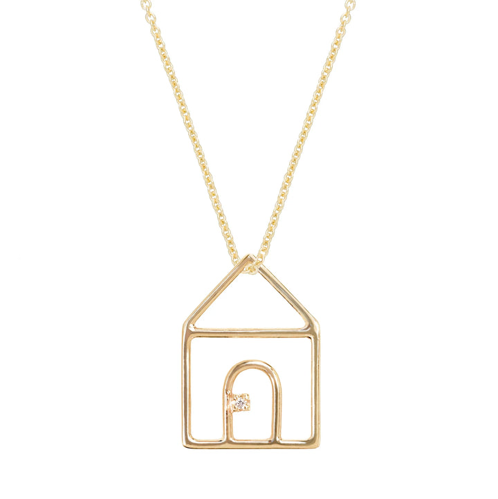 Gold necklace with a house-shaped pendant on a white background