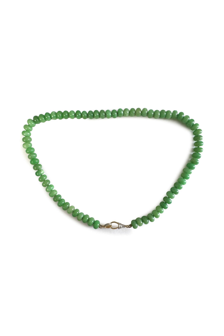 Green beaded necklace on a white background