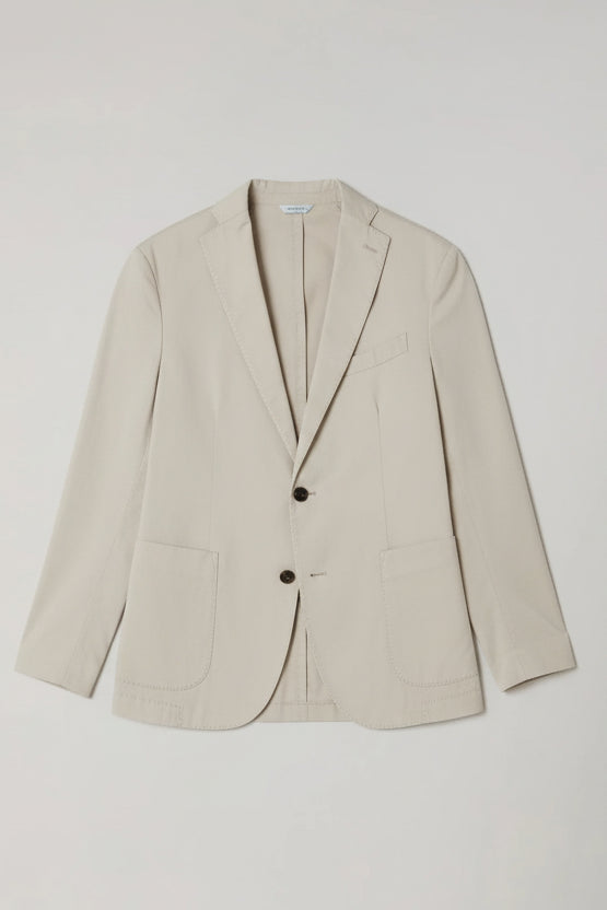 Green blazer on a light gray background
