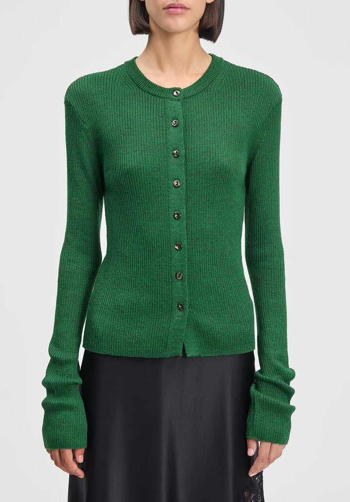 Green cardigan worn by a person on a white background
