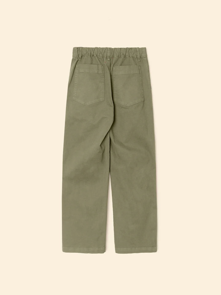 Green pants on a beige background