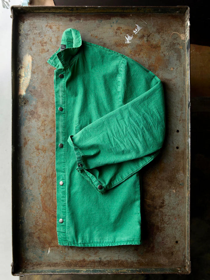 Green shirt on a rusty metal surface