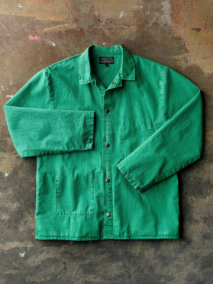 Green shirt on a textured brown background
