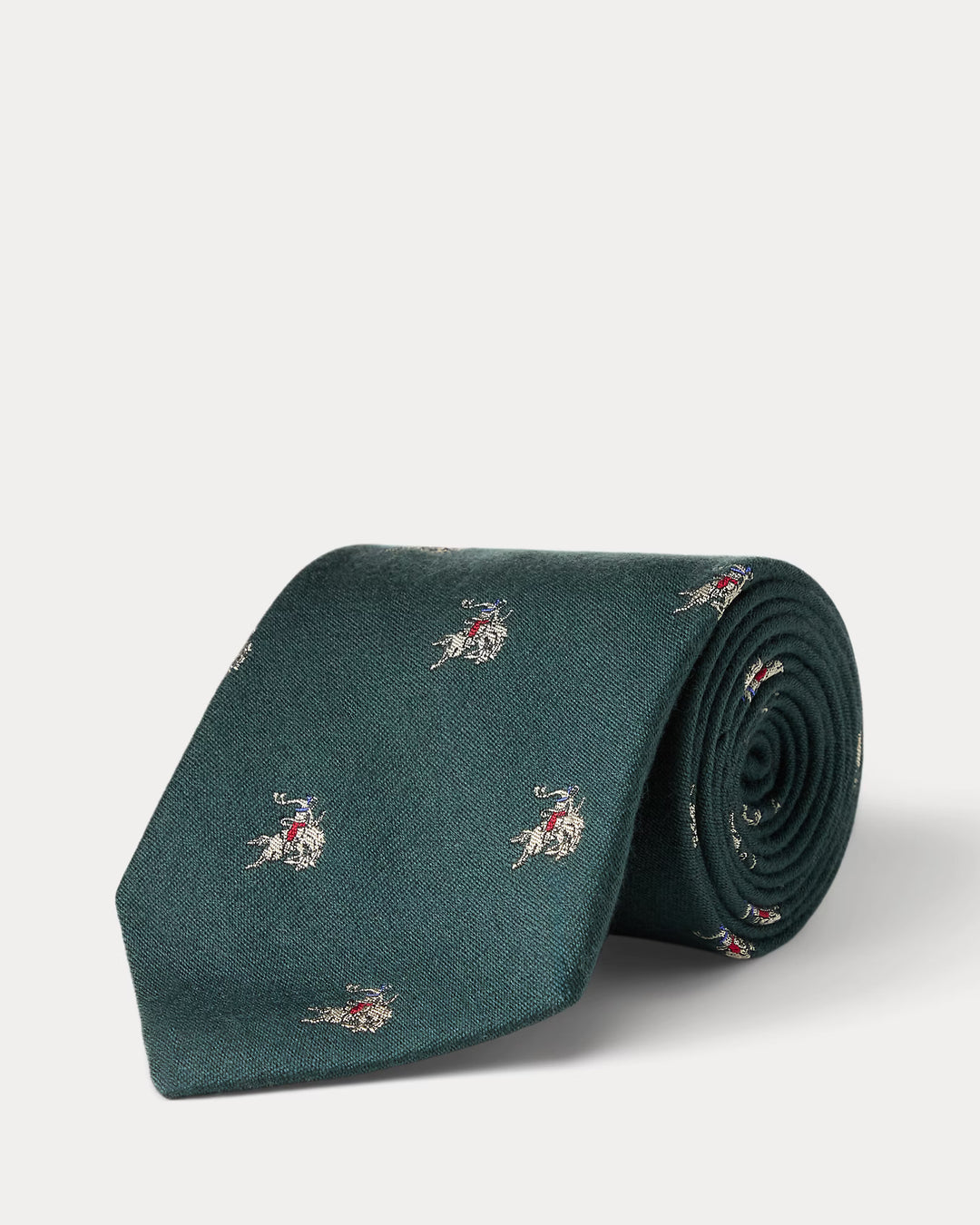 Green tie with small patterns on a light gray background