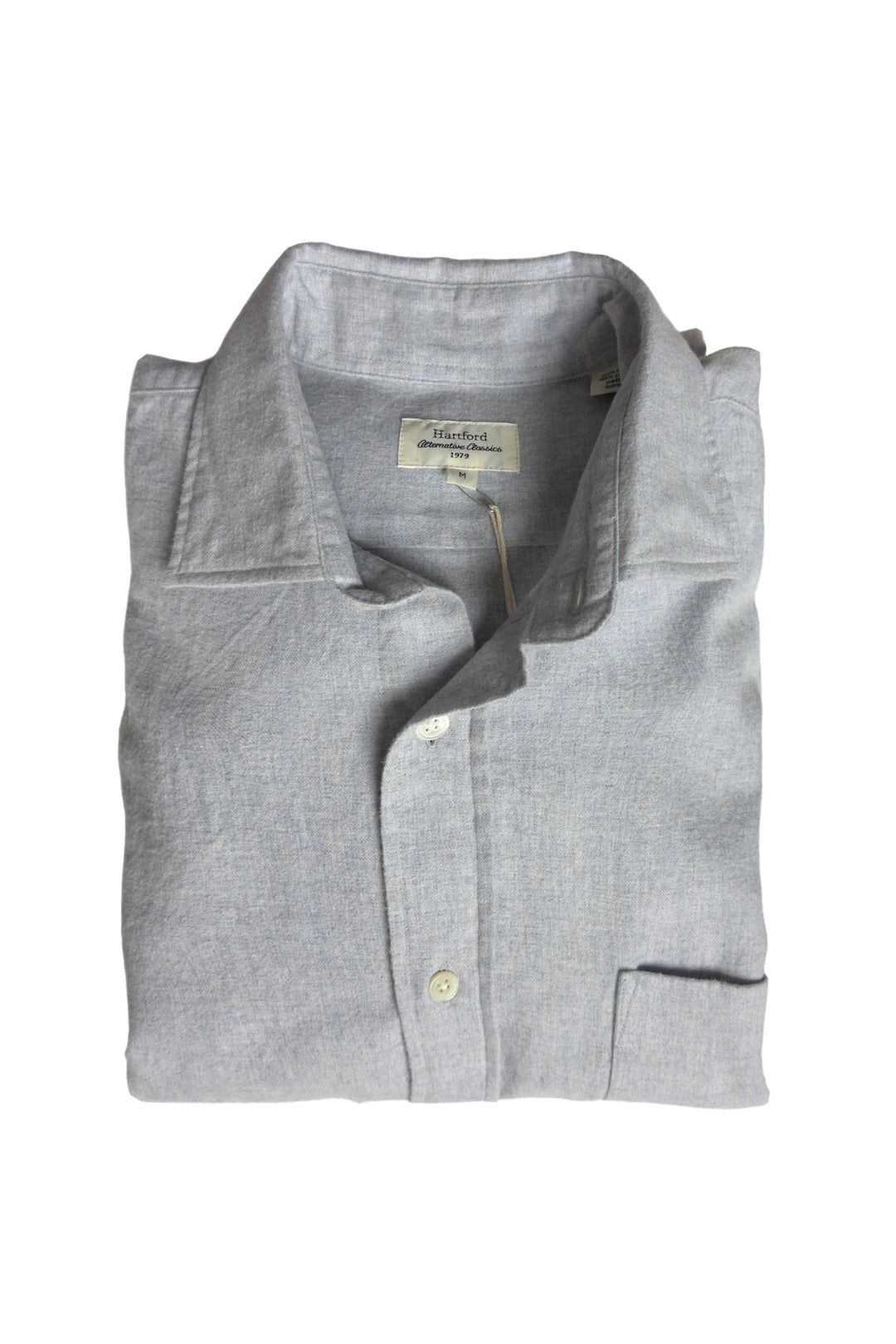 Folded gray shirt with a brand label on a white background