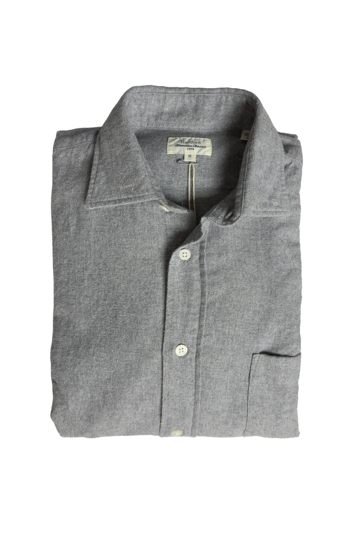 Folded gray shirt with a brand label on a white background