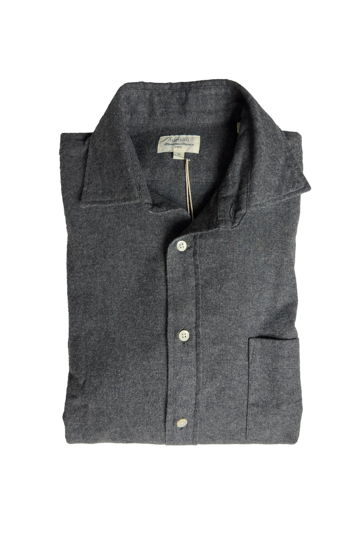 Folded gray shirt with button details on a white background