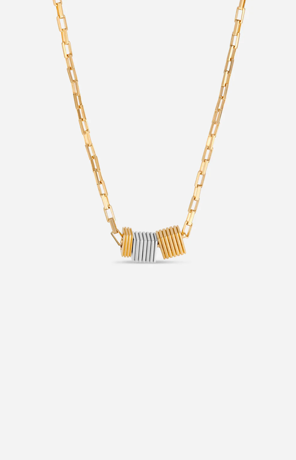 Gold and silver necklace on a light gray background
