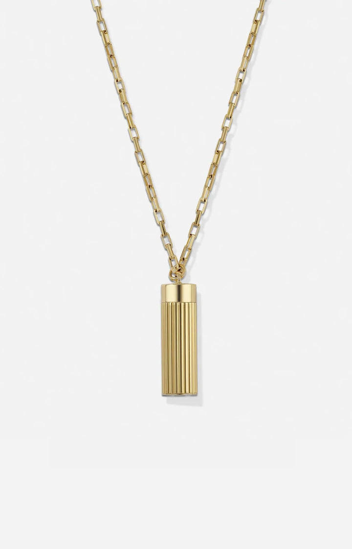 Gold necklace with a cylindrical pendant on a white background