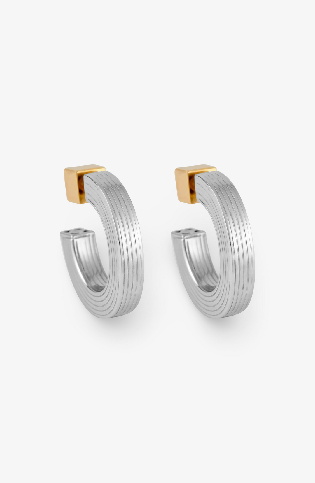 Pair of silver hoop earrings with gold accents on a white background