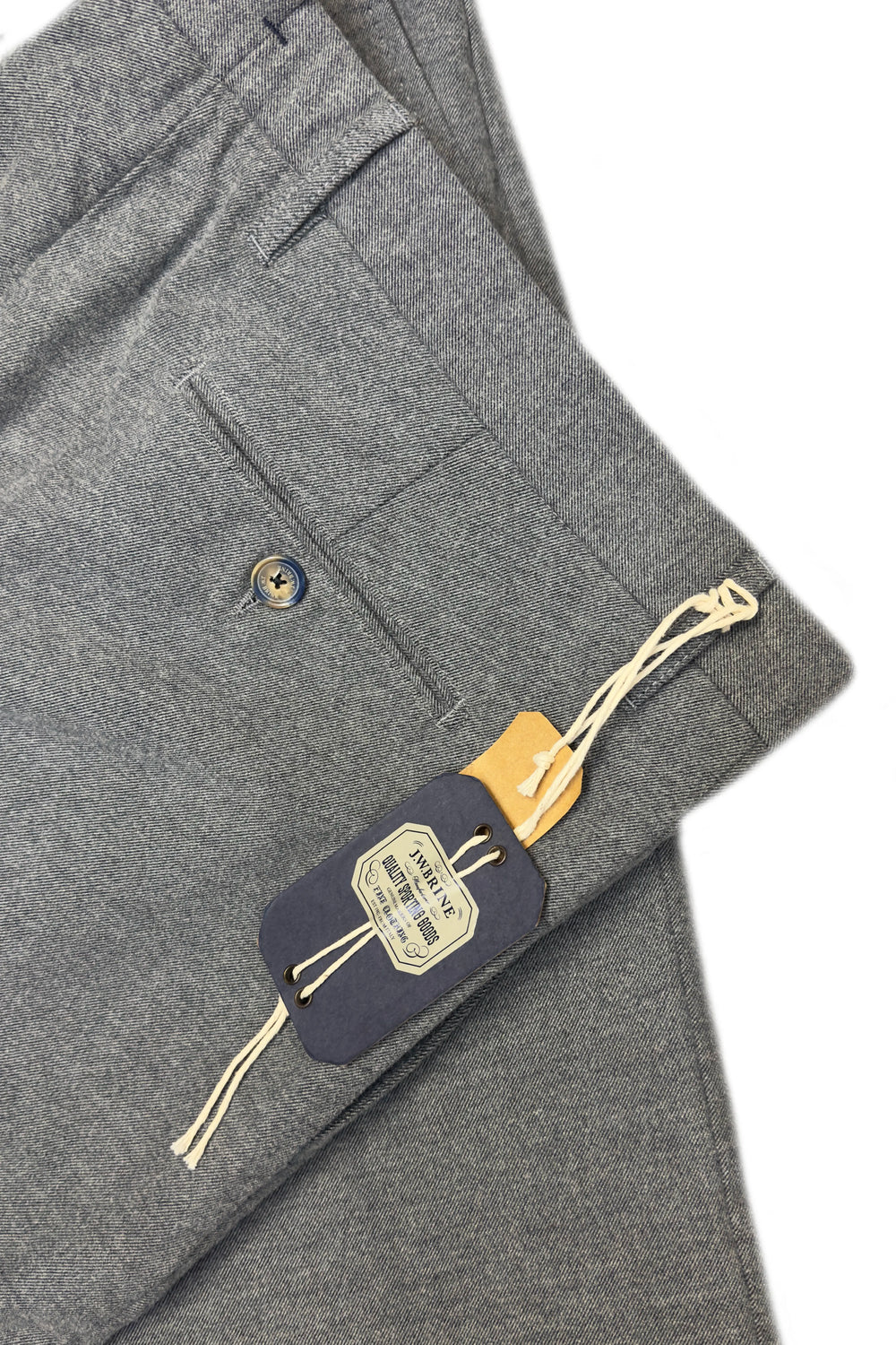 Gray pants with a brand tag on a white background