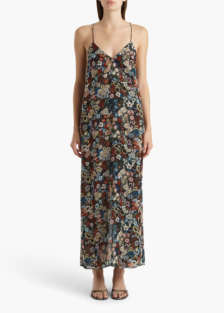 Woman wearing a floral slip dress on a white background