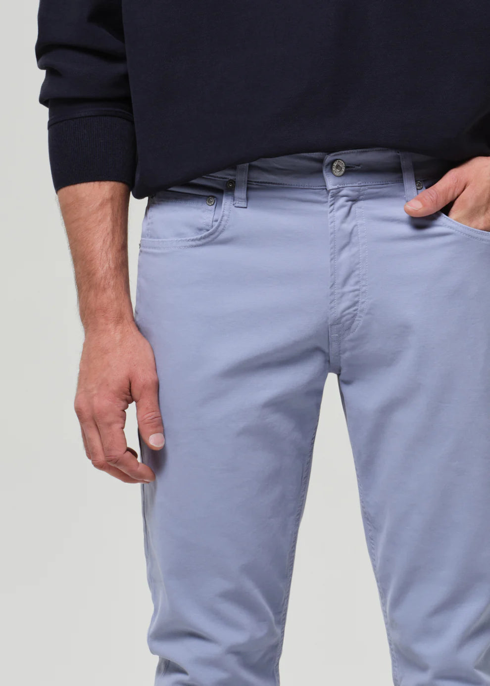 Light blue jeans worn by a person on a plain background
