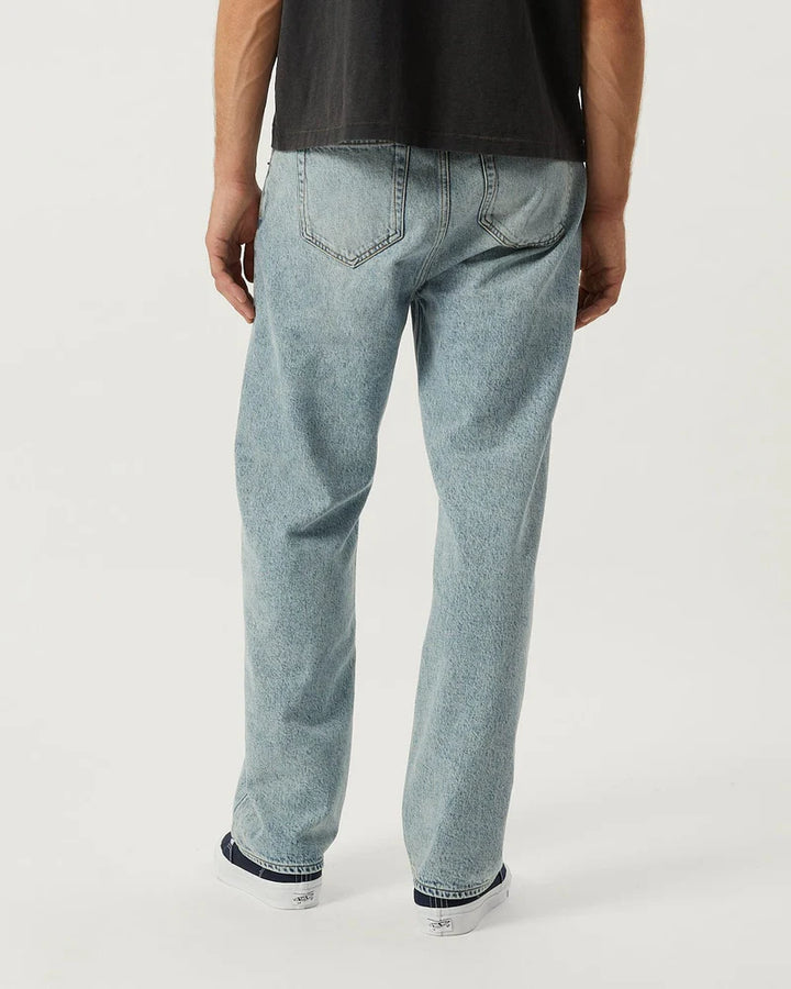 Light blue jeans worn by a person on a white background