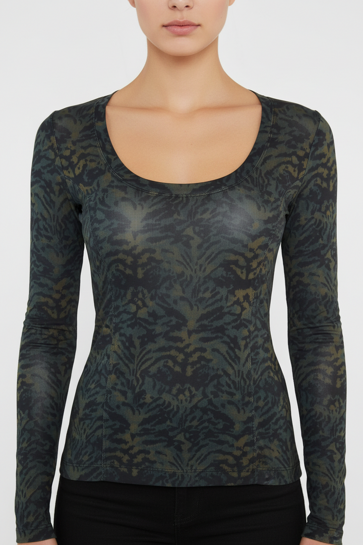 Long-sleeve patterned top worn by a person on a white background