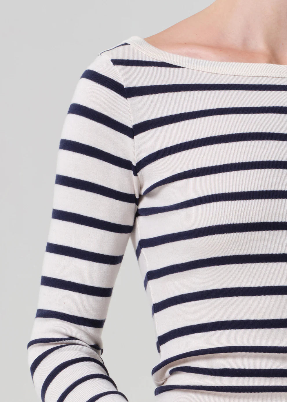 Navy and white striped long-sleeve top on a plain background