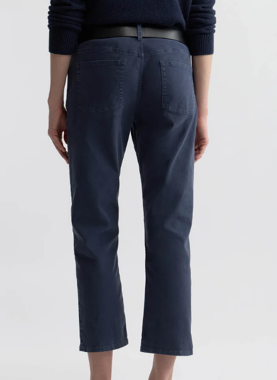 Navy blue pants worn by a person on a white background