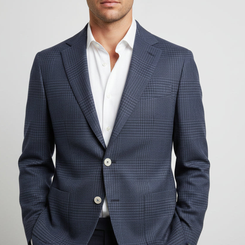 Navy checkered suit jacket over a white shirt on a gray background