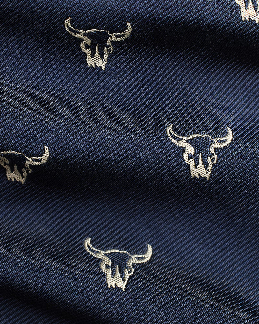 Navy fabric with silver bull skull patterns