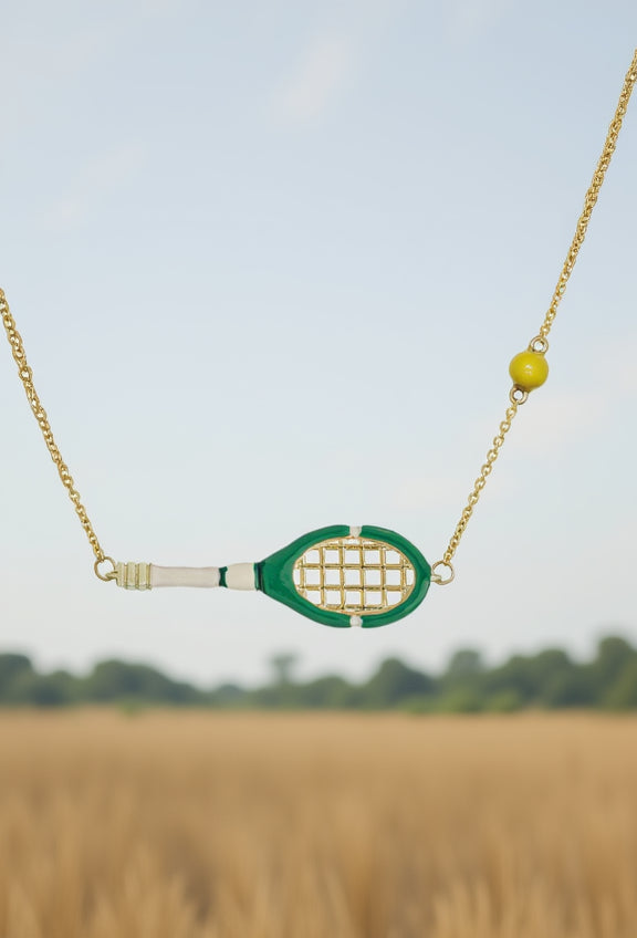 Necklace with a tennis racket pendant against a blurred natural background