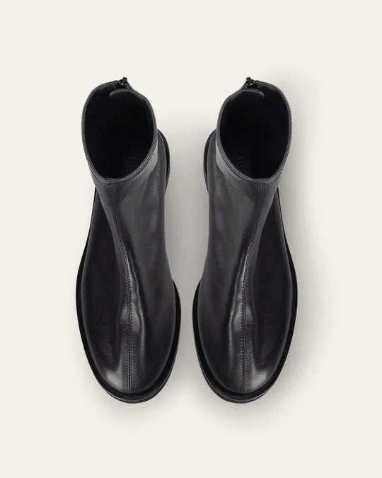 Pair of black leather ankle boots on a white background