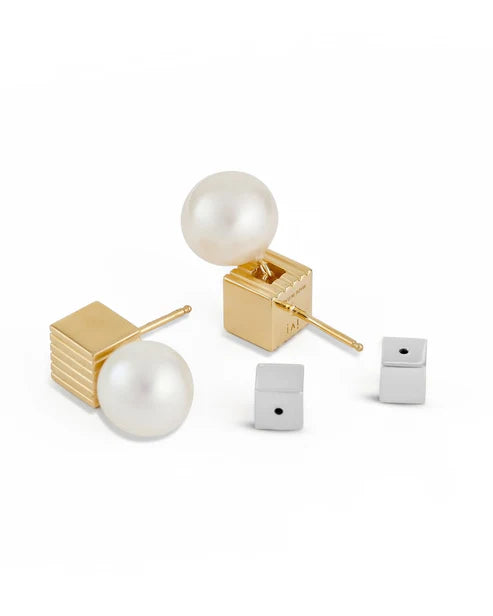 Pair of pearl stud earrings with gold and silver posts on a white background
