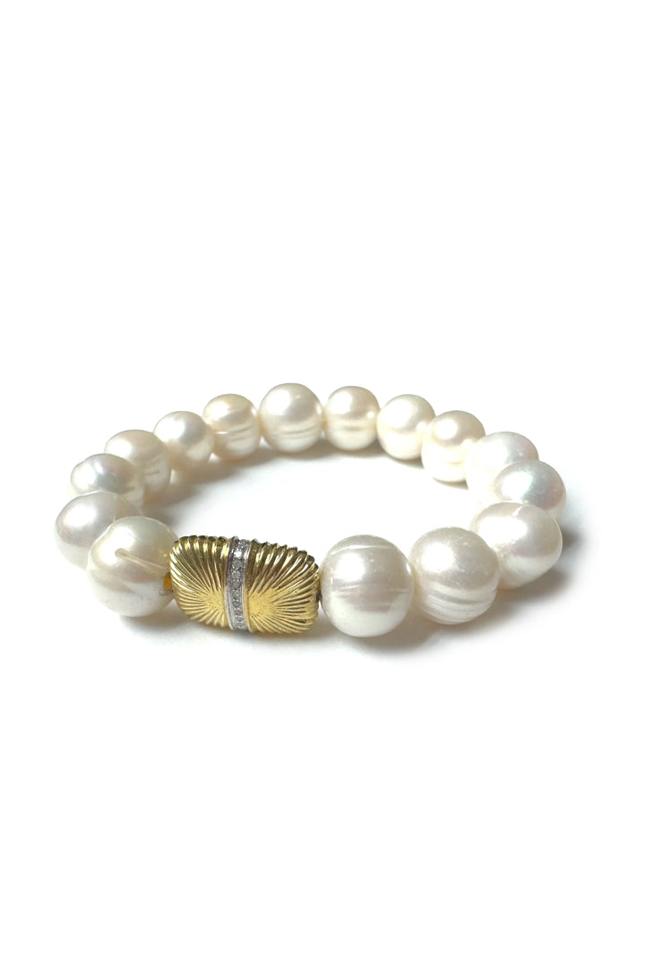 Pearl bracelet with a gold and silver clasp on a white background