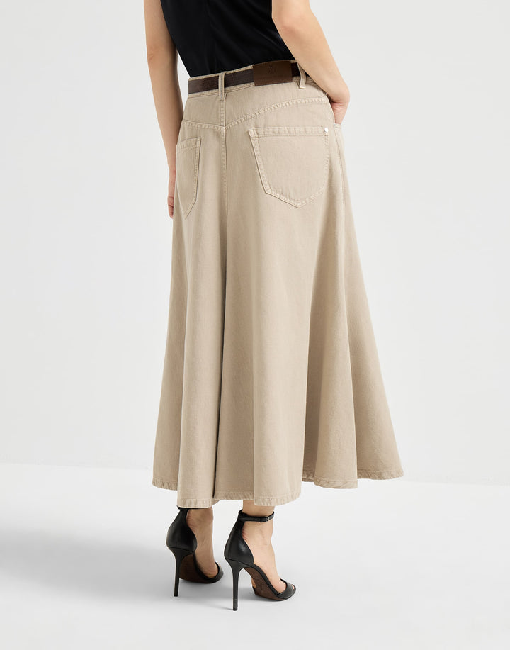 Person wearing a beige skirt with a plain background