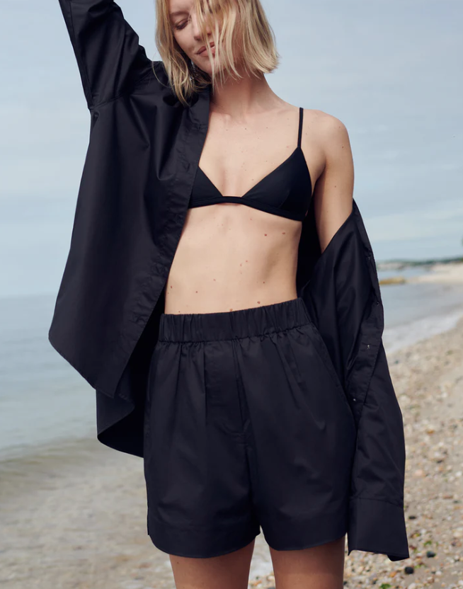 Person wearing a black outfit on a beach