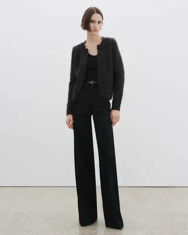 Person wearing a black suit with a white background