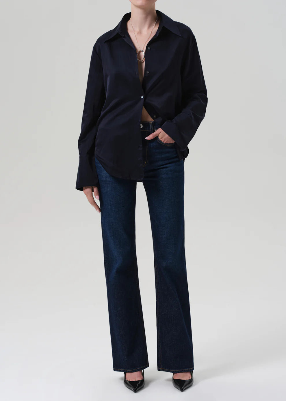 Person wearing a navy blue shirt and pants on a white background