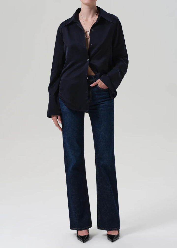 Person wearing a navy blue shirt and pants on a white background