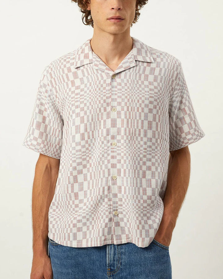Person wearing a patterned short-sleeve shirt with a white background