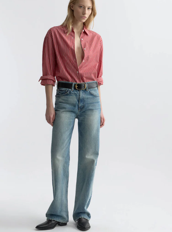 Person wearing a red striped shirt and blue jeans on a white background